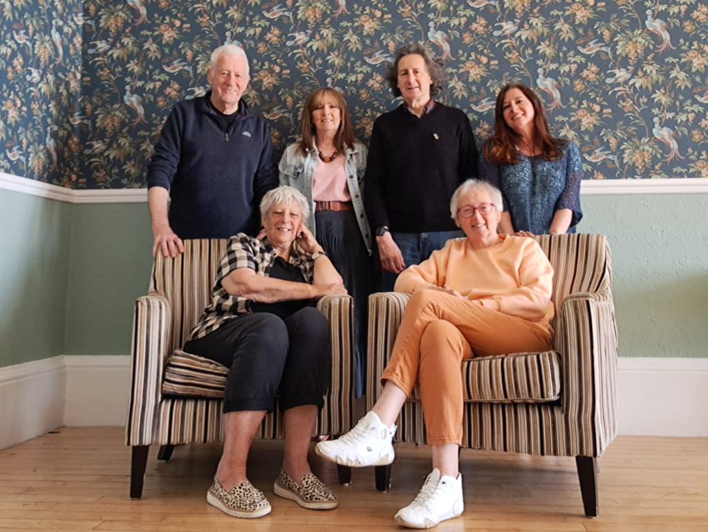 Group photo of the Friends of Golowan volunteer team in Penzance, Cornwall, smiling together as the community ambassadors supporting the Golowan Festival