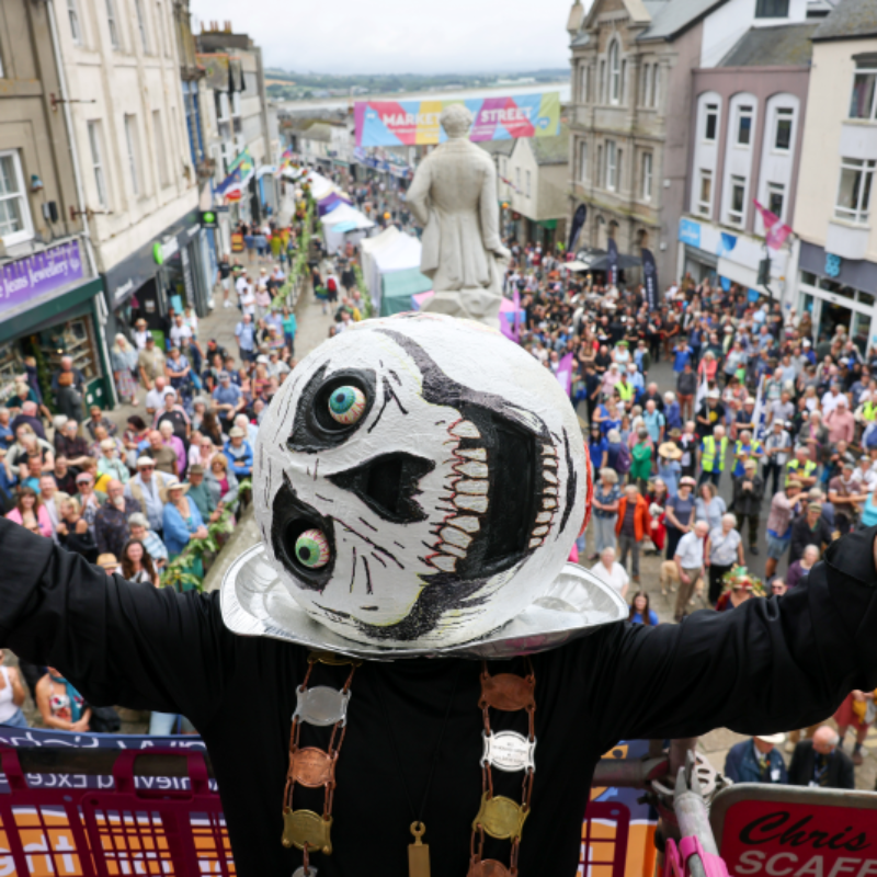 Winner of the 2025 Mock Mayor Awards smiling and holding their award at the Golowan Festival, photographed by Greg Martin