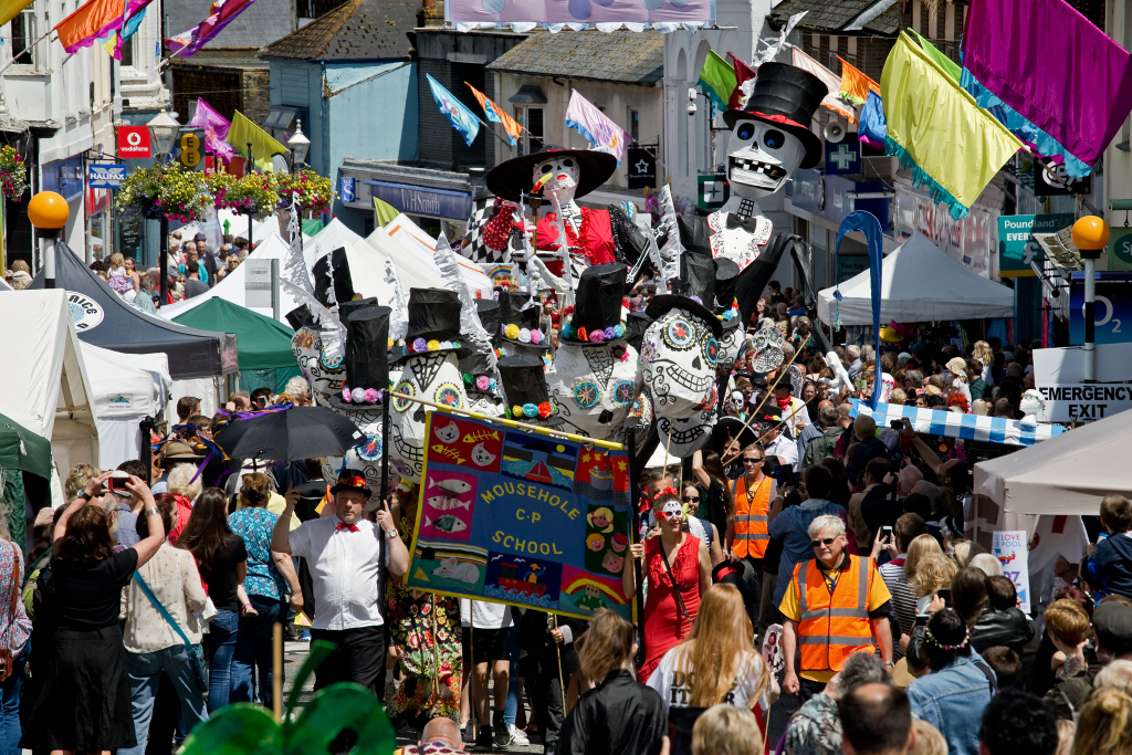 Day of the Dead–themed Mousehole School children taking part in the Dinner Parade on Mazey Day at the Golowan Festival 2016, wearing colourful costumes and face paint.